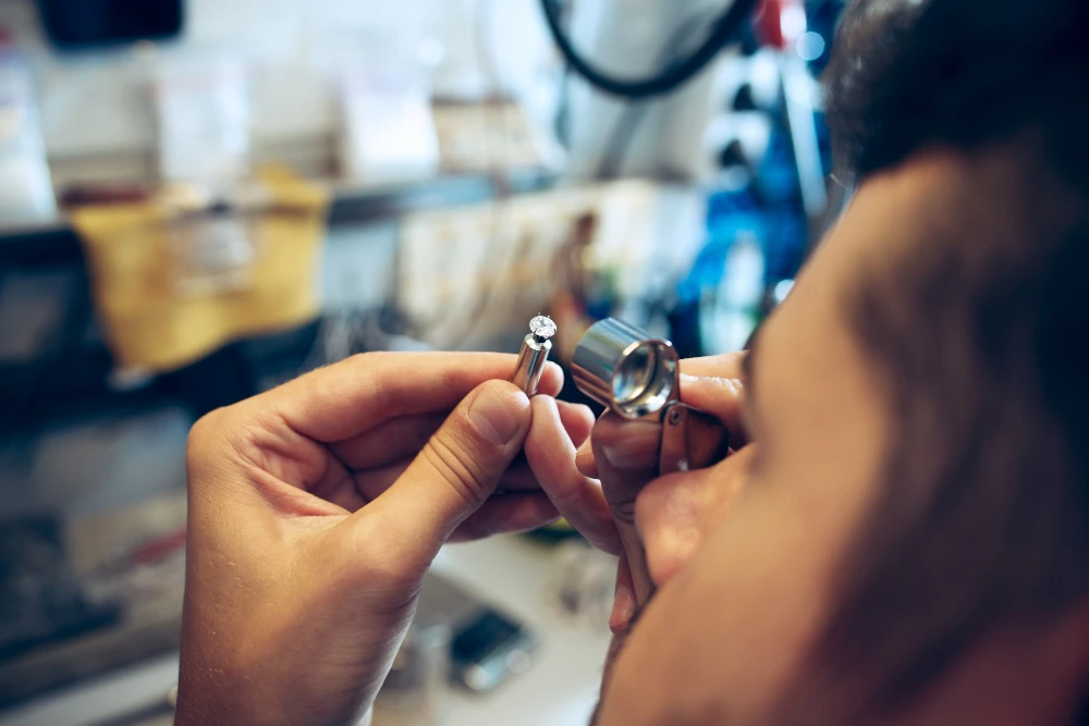 a man testing the stone of a jewelry